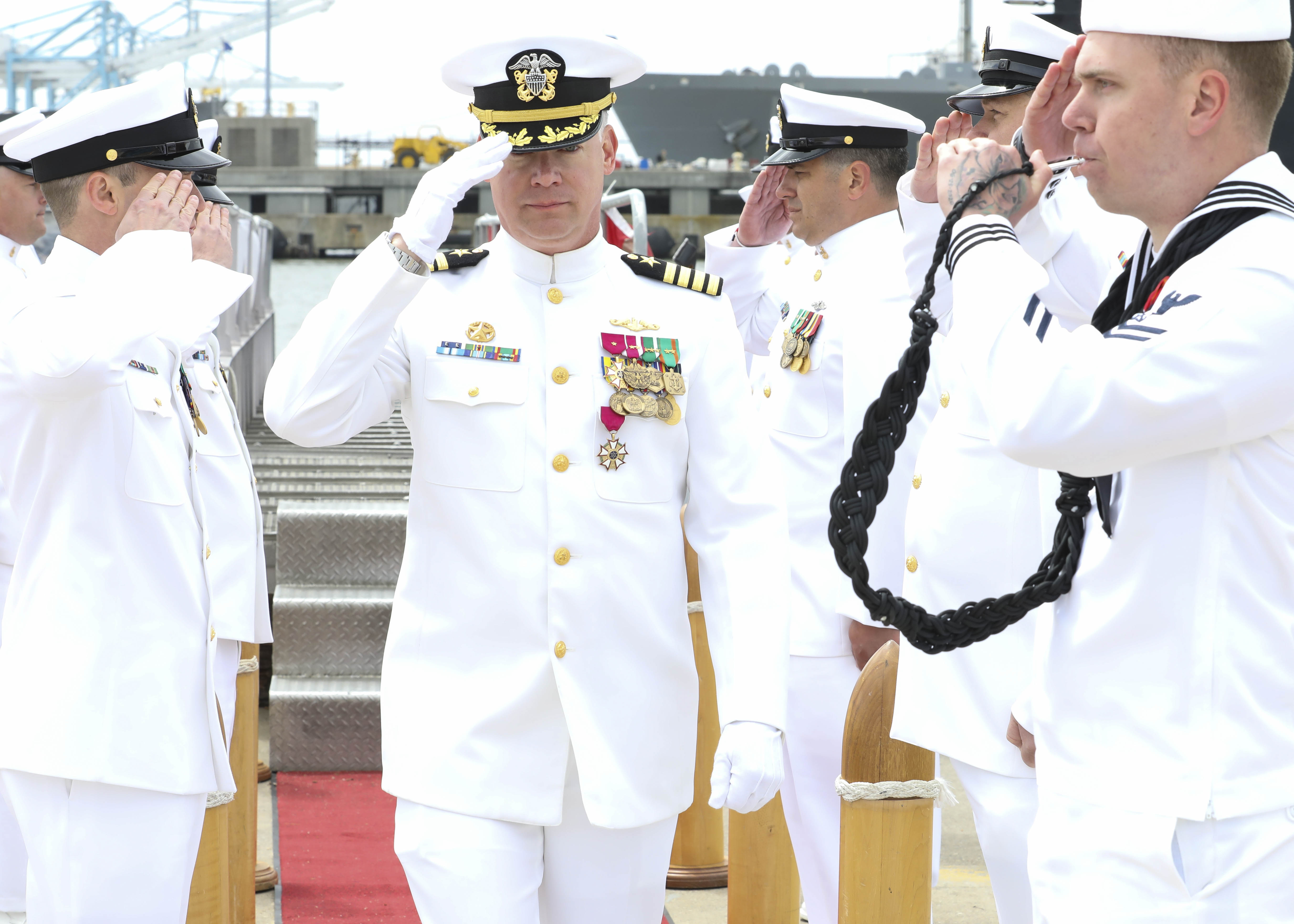 Capt. Jason Pittman renders a salute to sideboys during the Commander, Submarine Squadron (CSS) SIX change of command ceremony, April 25.