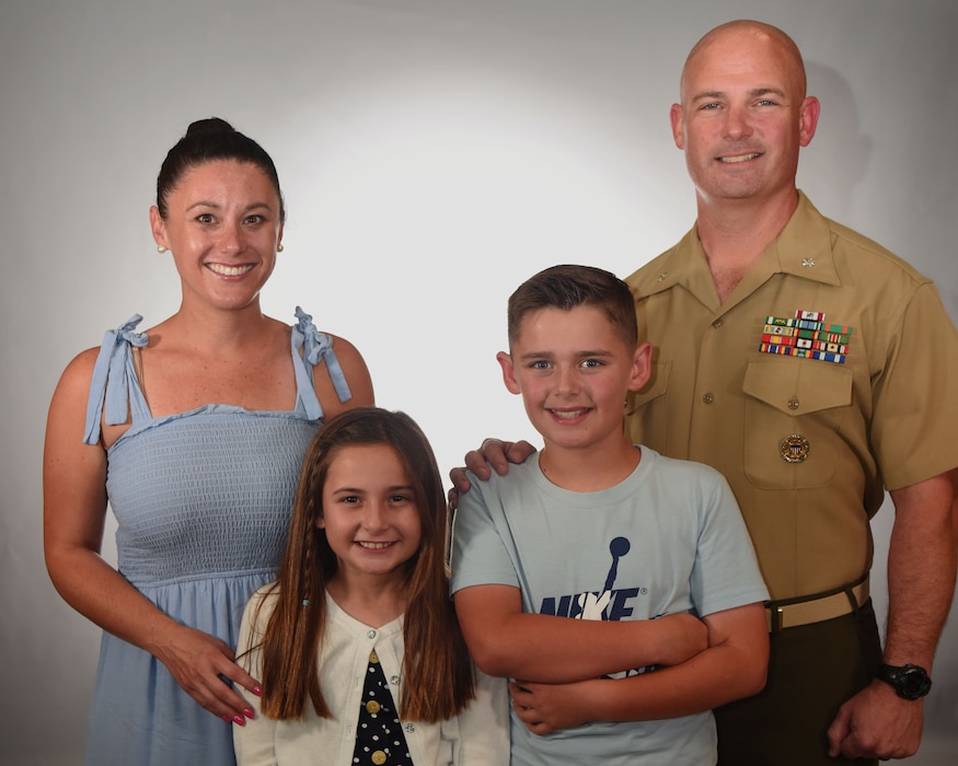U.S. Marine Corps Lt. Col. Thomas Coyle, Goodfellow Marine Corps Detachment commanding officer, stands with Felicia Coyle, his wife; Macie Coyle, his daughter; and Brody Coyle, his son, at the public affairs office, Goodfellow Air Force Base, Texas, April 23, 2024. Lt. Col. Coyle commissioned on May 8, 2005. (U.S. Air Force photo by Airman 1st Class Madison Collier)