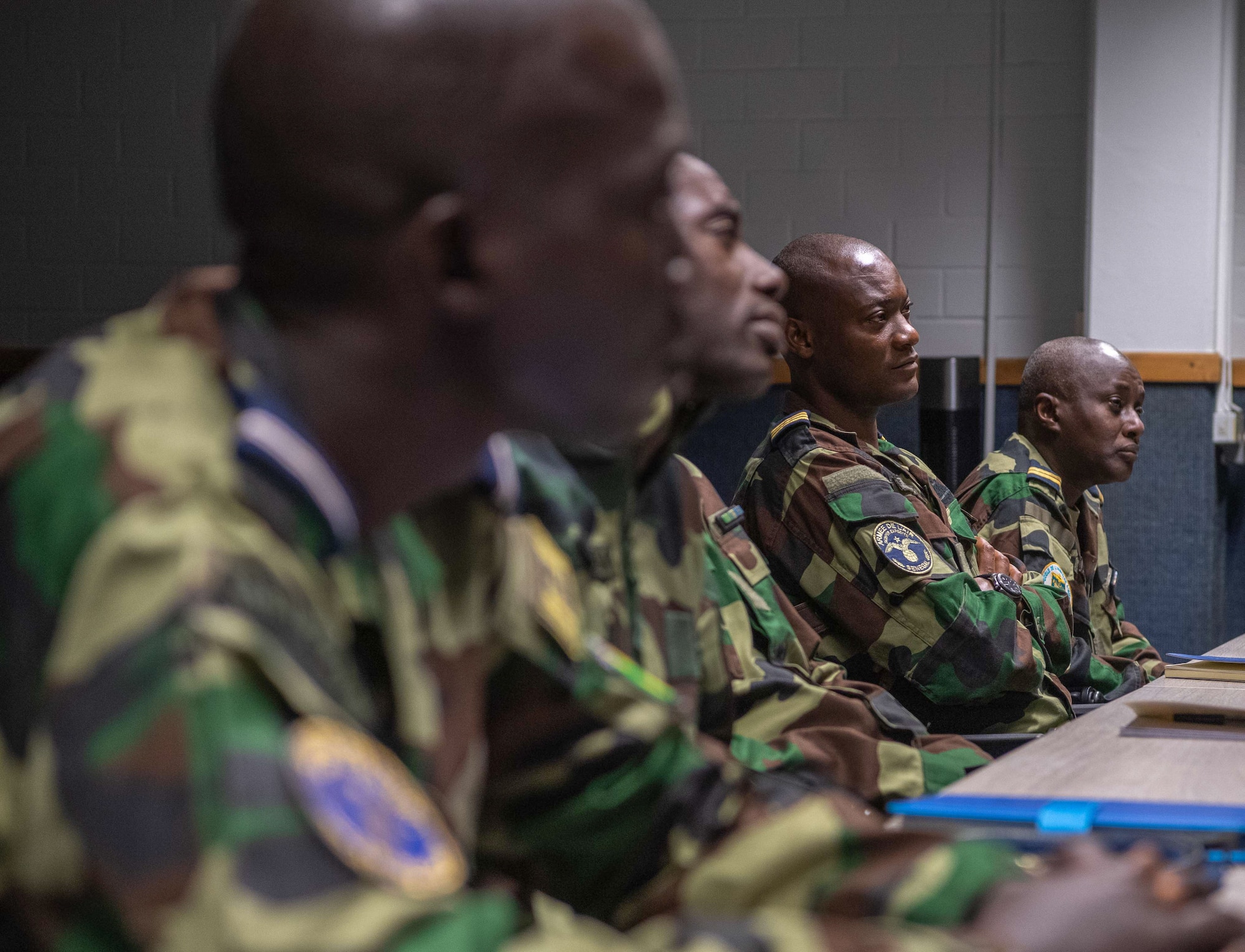 A group of men sit down