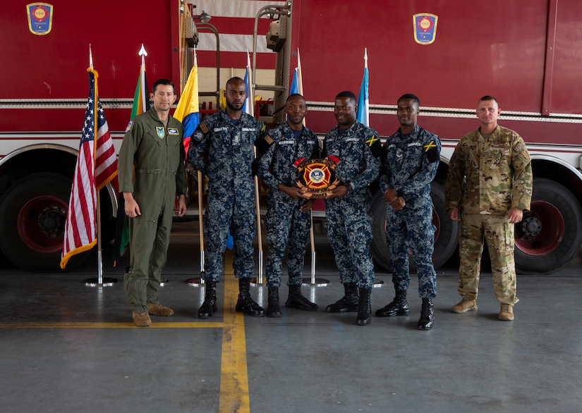 Jamaican firefighters receive the “Top Country Performers” Award for the Firefighter Challenge Obstacle Course at the CENTAM SMOKE Closing Ceremony at Soto Cano Air Base, Honduras April 26, 2024. The team averaged a time of two minutes and 43 seconds for the course, which consisted of techniques and procedures on hose advancements up two stories, nozzle control, vehicle extrication, rescue operations and carrying a 150-pound mannequin.