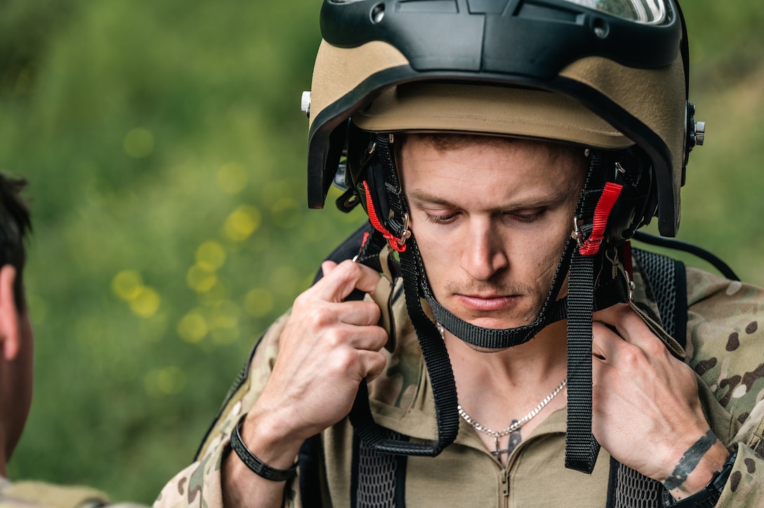 A man straps into a bomb suit