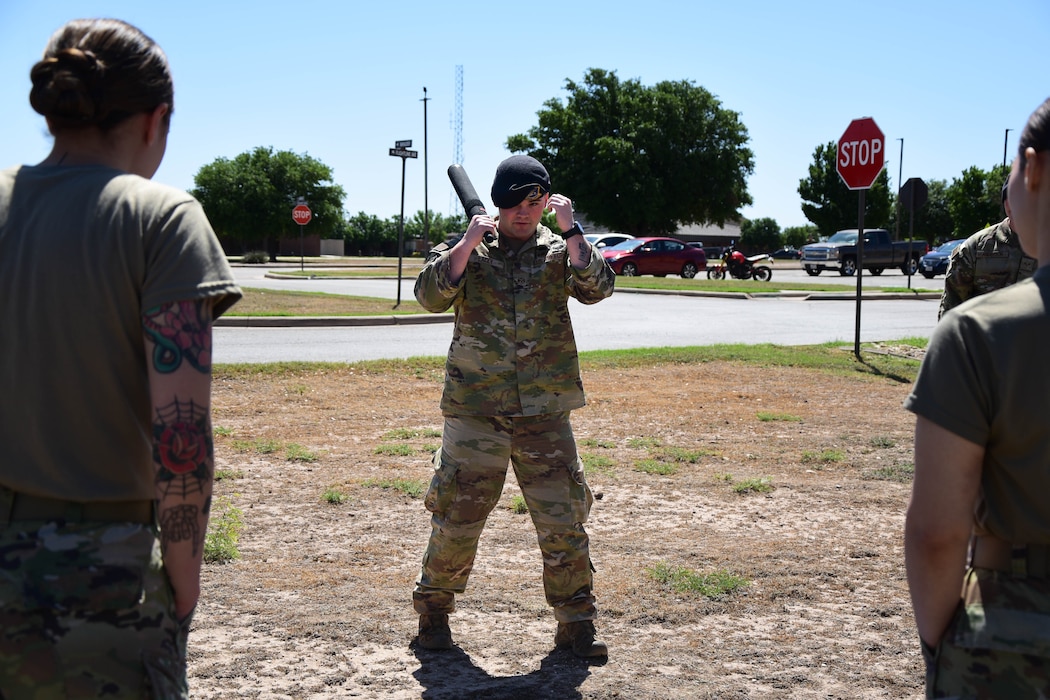 U.S. Air Force Staff Sgt. Josten Lacey, 17th Security Forces Squadron unit deployment manager, demonstrates the proper defensive stance during baton combative instruction at the Installation Deployment Readiness Cell, Goodfellow Air Force Base, Texas, April 11, 2024. A key part of the Expeditionary Readiness Training course is day four, where students are given tactical and combative instruction from security forces. (U.S. Marine Corps photo by Cpl. Jessica Roeder)