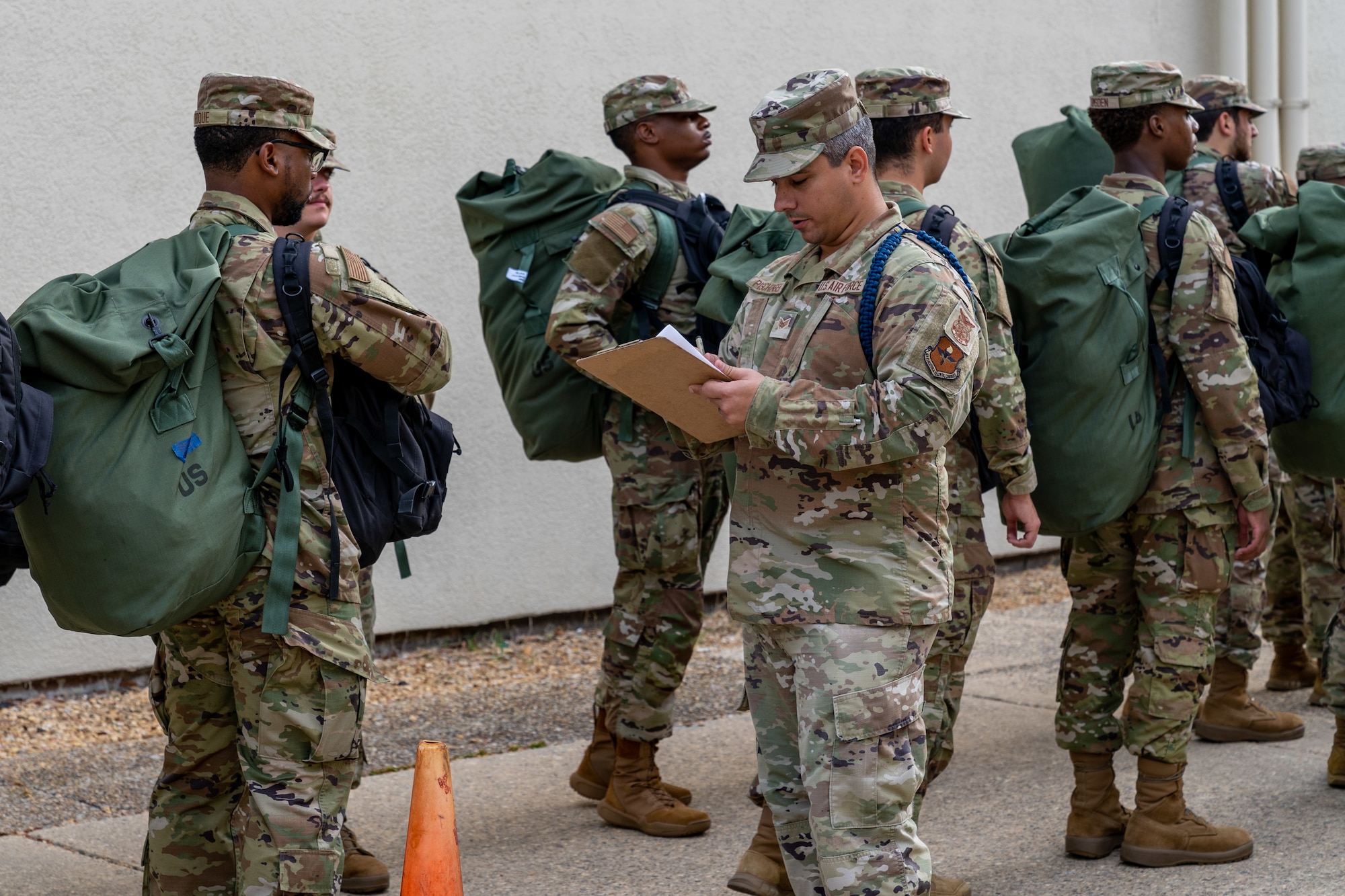 Students with the 335th Training Squadron make their way to an in-processing center at Allee Hall to shelter during a hurricane exercise at Keesler Air Force Base, Mississippi, April 26, 2024. Keesler personnel participated in exercise scenarios in preparation for hurricane season. (U.S. Air Force photo by Andrew Young)