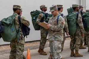 Students with the 335th Training Squadron make their way to an in-processing center at Allee Hall to shelter during a hurricane exercise at Keesler Air Force Base, Mississippi, April 26, 2024. Keesler personnel participated in exercise scenarios in preparation for hurricane season. (U.S. Air Force photo by Andrew Young)
