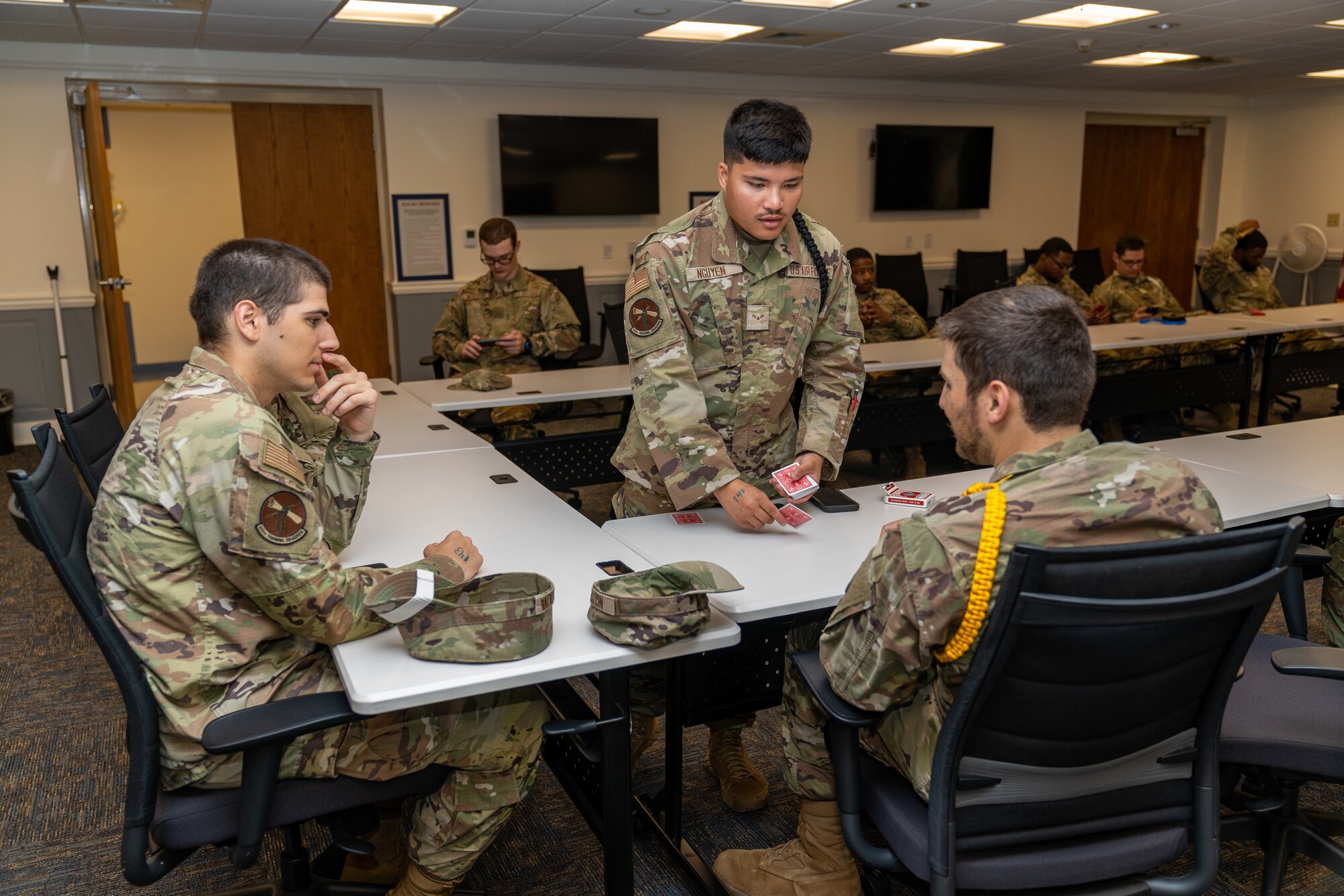 Students with the 335th Training Squadron play games at Allee Hall while sheltering during a hurricane exercise at Keesler Air Force Base, Mississippi, April 26, 2024. Keesler personnel participated in exercise scenarios in preparation for hurricane season. (U.S. Air Force photo by Andrew Young)