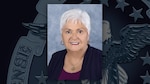A portrait of Darlene Ferrante with a background featuring the DLA emblem