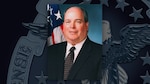 A portrait of Kenneth Winslette with an American flag behind him on a background with the DLA emblem