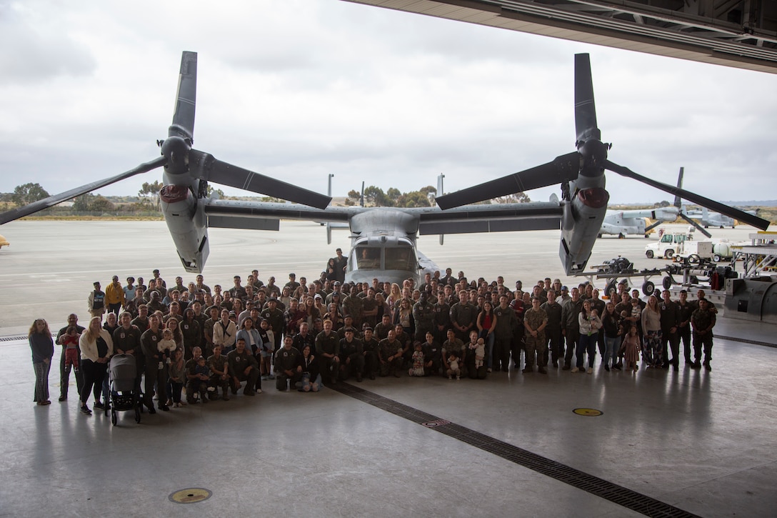 U.S. Marines with Marine Medium Tiltrotor Squadron (VMM) 161, Marine Aircraft Group 16, 3rd Marine Aircraft Wing, and their families pose for a group photo during the VMM-161 Bring Your Family to Work Day at Marine Corps Air Station Miramar, California, April 26, 2024.  The event gave families of the VMM-161 “Grayhawks” the opportunity to see what their Marines do daily and fostered squadron camaraderie. (U.S. Marine Corps photo by Cpl. Daniel Childs)