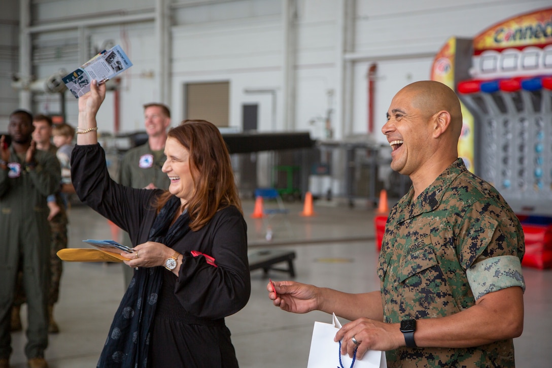Megan Heartwell, left, a deployment readiness coordinator with Marine Aircraft Group 16, 3rd Marine Aircraft Wing, and U.S. Marine Corps Sgt. Maj. Joel Angulo, sergeant major of Marine Medium Tiltrotor Squadron (VMM) 161, MAG-16, draw raffle tickets during the VMM-161 Bring Your Family to Work Day at Marine Corps Air Station Miramar, California, April 26, 2024.  The event gave families of the VMM-161 “Grayhawks” the opportunity to see what their Marines do daily and fostered squadron camaraderie. (U.S. Marine Corps photo by Cpl. Daniel Childs)