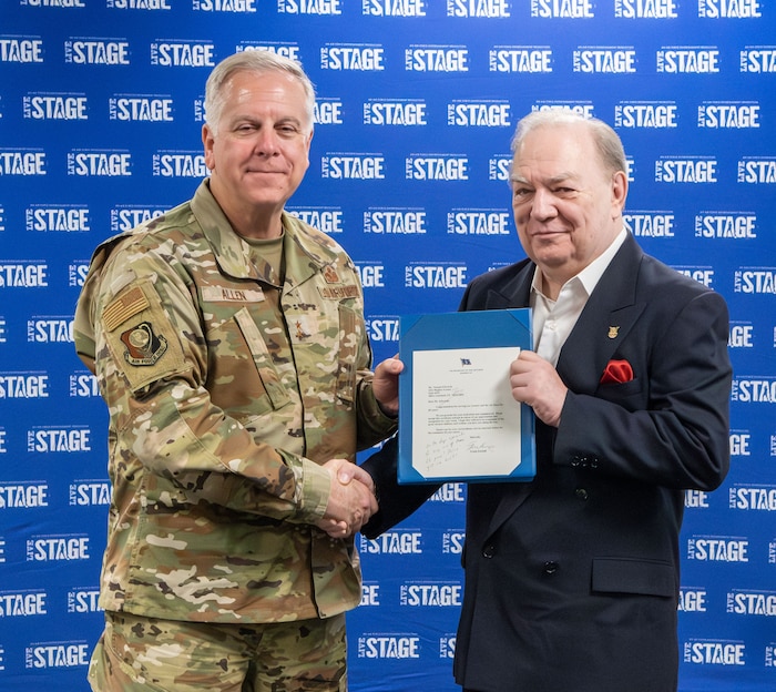 Allen at left, Edwards at right shaking hands and holding certificate