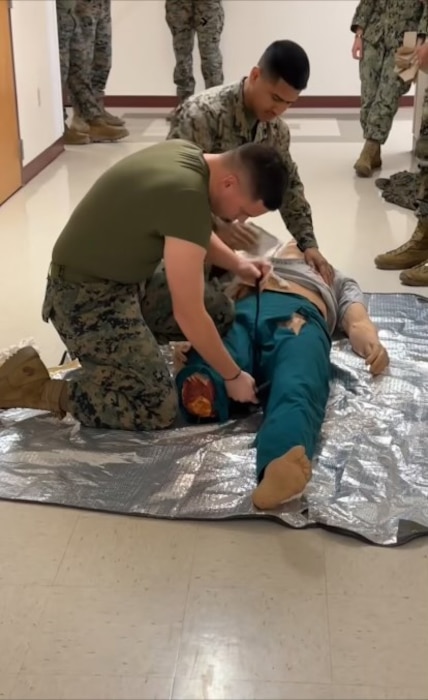 Marines of Support Company train on Tactical Combat Casualty Care (TCCC).  Here they are practicing applying a tourniquet and packing gunshot wounds to a casualty simulator. This advanced training aid provides realistic training and monitors the effectiveness of the Marine’s actions.