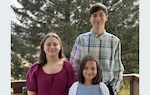 Liam (age 14), Ansley (age 12), and Norah (age 10) Goodison are recognized by Base Kodiak during Month of the Military Child for their contributions to the local community. (U.S. Coast Guard photo)