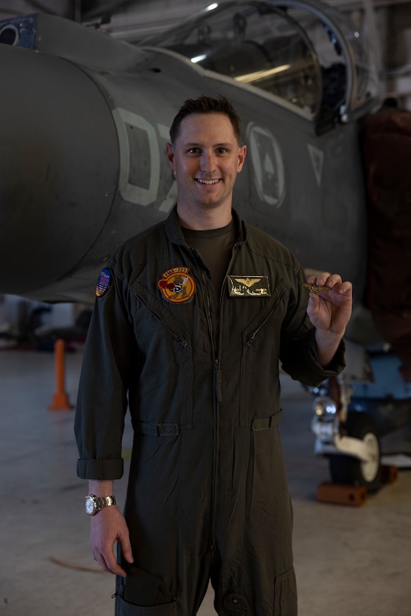 U.S. Marine Corps Capt. Raymond Hower, a native of California and an AV-8B Harrier II jet pilot with Marine Attack Squadron (VMA) 223, poses for a photo holding his great-uncle Louis A. Conter's naval aviator wing insignia at Marine Corps Air Station Cherry Point, North Carolina, April 18, 2024. Conter was the last known survivor of the USS Arizona during the attack on Pearl Harbor in 1941 and passed away April 1, 2024. Hower flew U.S. flags and Conter's naval aviator wing insignia during the flight. Conter served in the U.S. Navy from 1939 to 1967. (U.S. Marine Corps photo by Lance Cpl. Orlanys Diaz Figueroa)