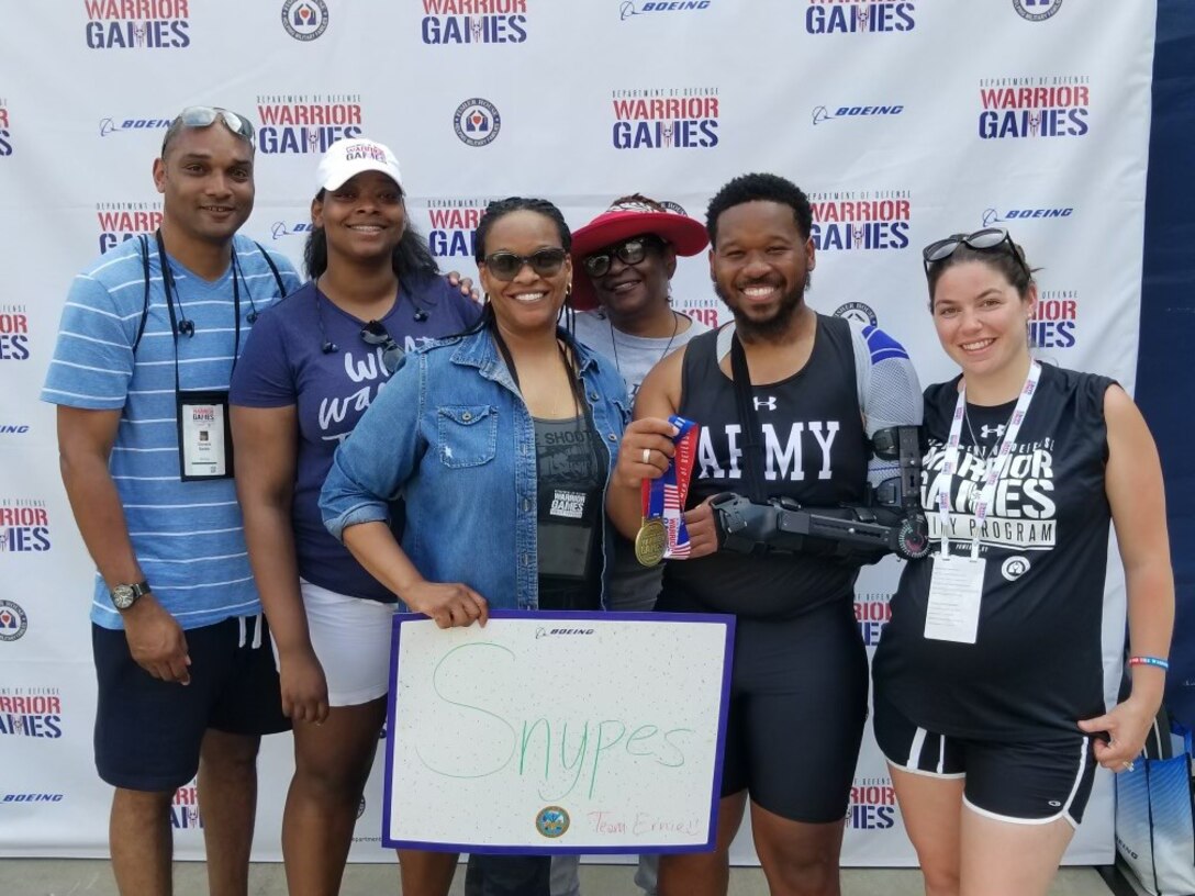 Snypes family celebrates with David and his multiple medals at the 2022 Department of Defense Warrior Games