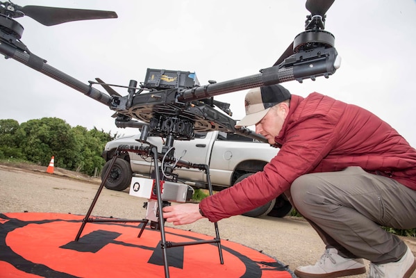U.S. Navy Lt. Corbin Mellow, a student at the Naval Postgraduate School (NPS), prepares for a data collection flight using an unmanned aircraft system (UAS) equipped with an infrared LiDAR, or Light Detection and Ranging, sensor.