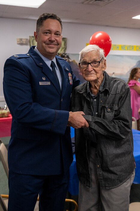 U.S. Air Force Col. Bobby Buckner, 23rd Maintenance Group commander, left, poses for a photo with James Herring, a retired U.S. Air Force chief master sergeant and WWII veteran.