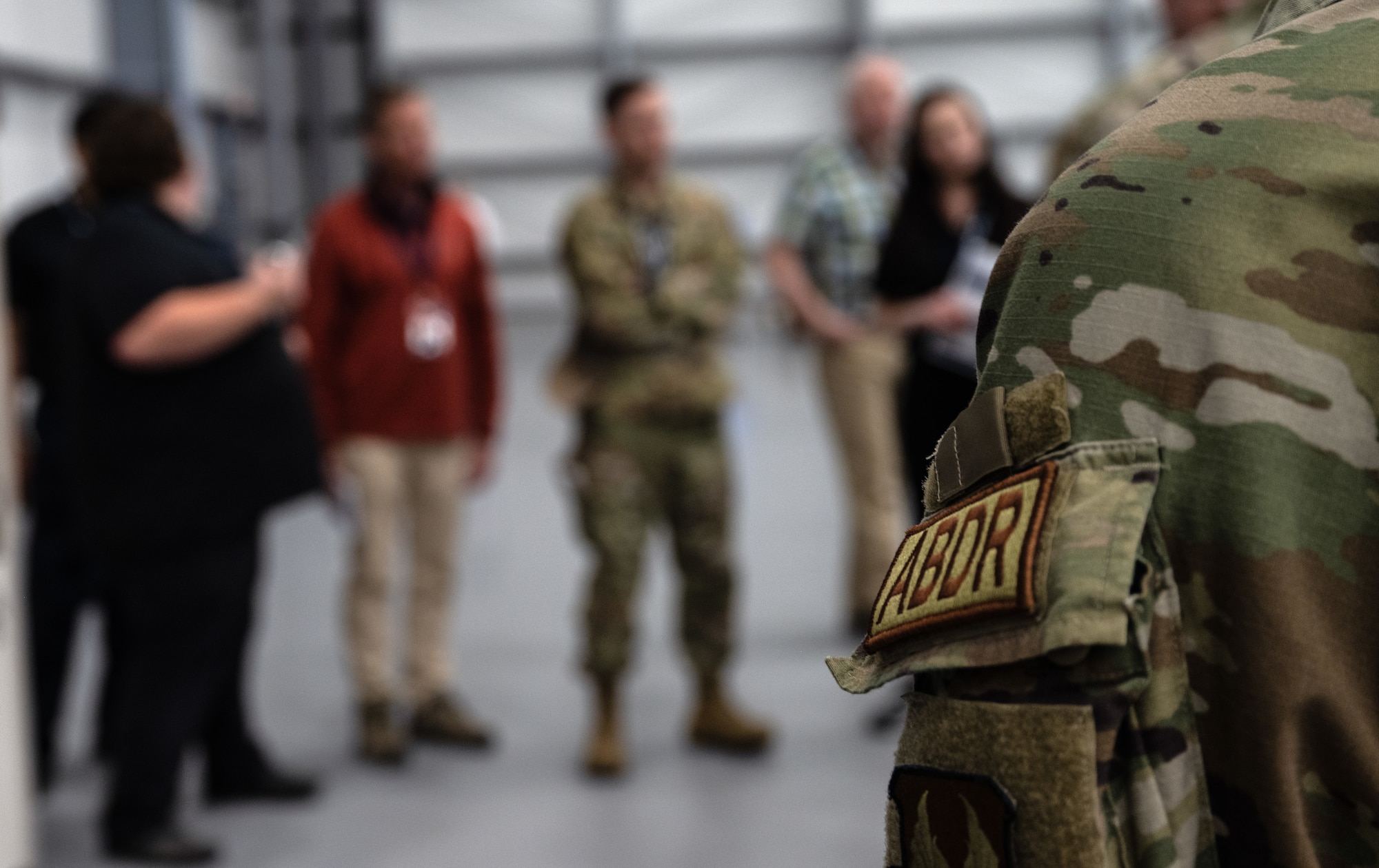 An Airman with an Air Battle Damage Repair patch listens to a brief during STRATO-Tech, a convention for sustainment of the KC-135 Stratotanker, April 23, 2024, in Wichita, Kansas. STRATO-Tech is an initiative under the Sustainment Technologies, Research and Automation for Transformative Operations Testbed that studies, develops and tests innovations to improve the efficiency and cost-effectiveness of the KC-135. (U.S. Air Force photo by Staff Sgt. Tryphena Mayhugh)