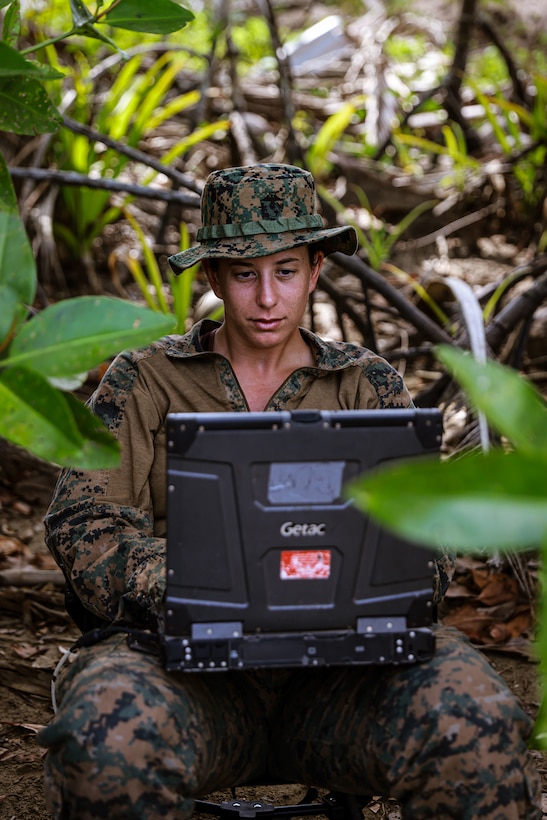 U.S. Marine Corps 1st Lt. Kaylee Mackenzie, left, a platoon commander assigned to Combat Logistics Battalion 15, 15th Marine Expeditionary Unit, establishes communications with the amphibious transport dock USS Somerset (LPD 25) during Exercise Balikatan 24 after offloading on Kemdeng Beach, San Vicente, Philippines, April 28, 2024.