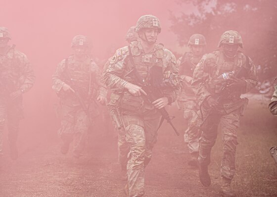 Staff Sgt. Brock Wilson, an Oklahoma City resident serving in the 120th Medical Company (Area Support), 120th Engineer Battalion, 90th Troop Command, (center) runs through smoke during the 2024 Oklahoma Army National Guard Best Warrior Competition at Camp Gruber Training Center, April 26, 2024. (Oklahoma National Guard photo by Sgt. Haden Tolbert)