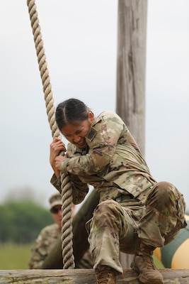 Spc. Lucy Stuteville, a Stillwater, Oklahoma resident serving in the 700th Brigade Support Battalion, 45th Infantry Brigade Combat Team, swings over an obstacle during the 2024 Oklahoma Army National Guard Best Warrior Competition at Camp Gruber Training Center, April 26, 2024. (Oklahoma National Guard photo by Staff Sgt. Bradley Cooney)