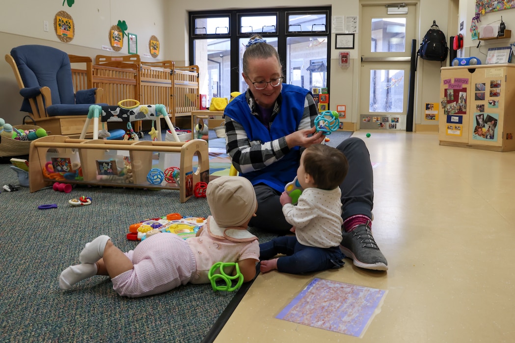 Debbie Kehishian, 9th Force Support Squadron Child Development Center (CDC) infant classroom lead teacher, plays with infants in the CDC at Beale Air Force Base, California, March 14, 2024.