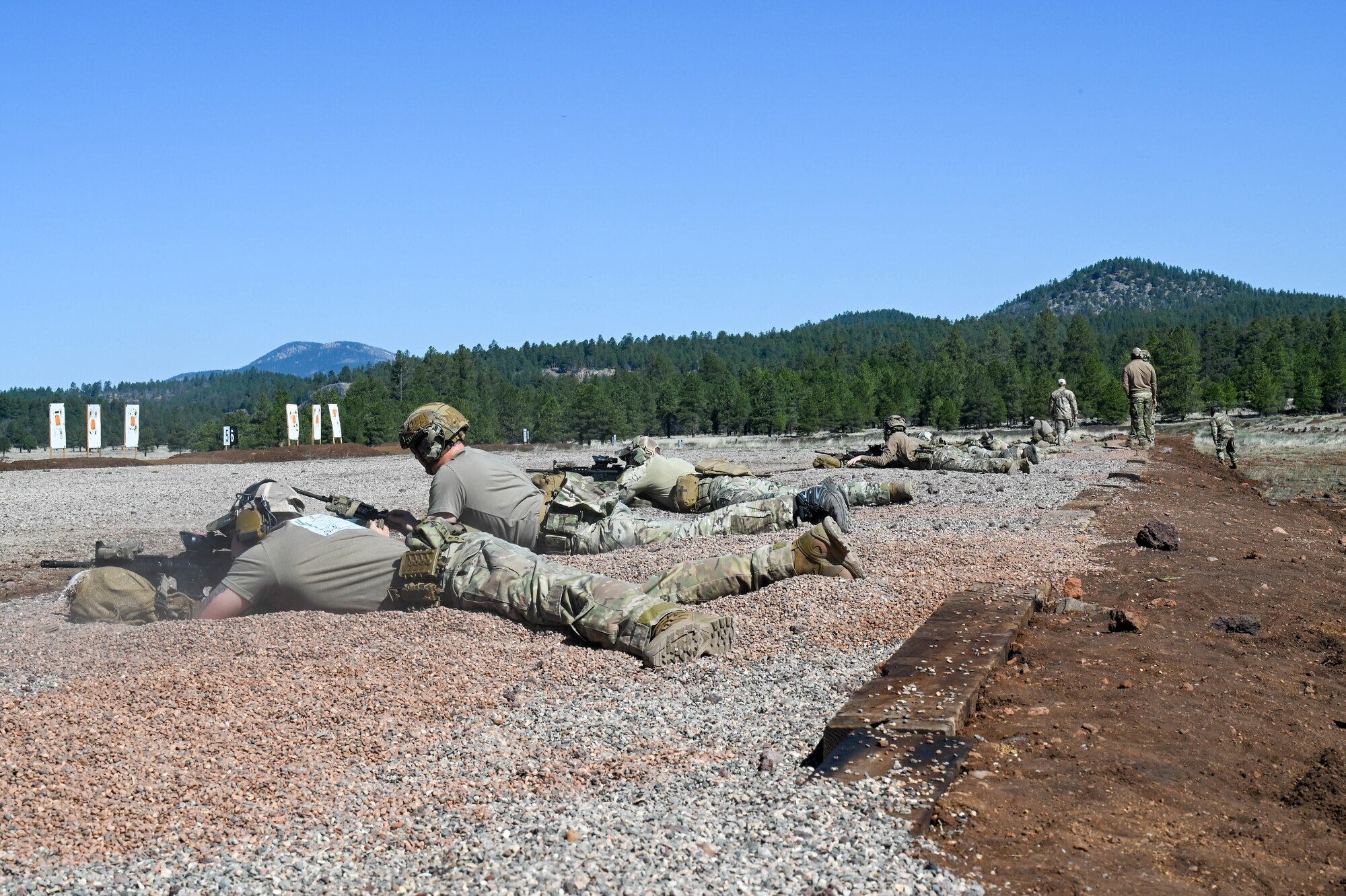U.S. Air Force Airmen assigned to the 56th Civil Engineer Squadron Explosive Ordnance Disposal flight zero in their M4 carbines before combat arms training during exercise Operation Pegasus at Camp Navajo, Arizona, April 21-26, 2024.