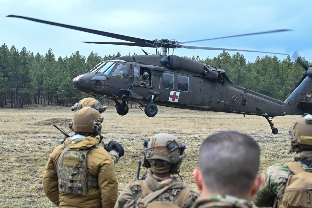 U.S. Air Force Airmen assigned to the 56th Civil Engineer Squadron Explosive Ordnance Disposal flight observe an Arizona National Guard UH-60 Black Hawk, assigned to the ANG Silverbell Army Heliport in Marana, Arizona, during Operation Pegasus at Camp Navajo, Arizona,