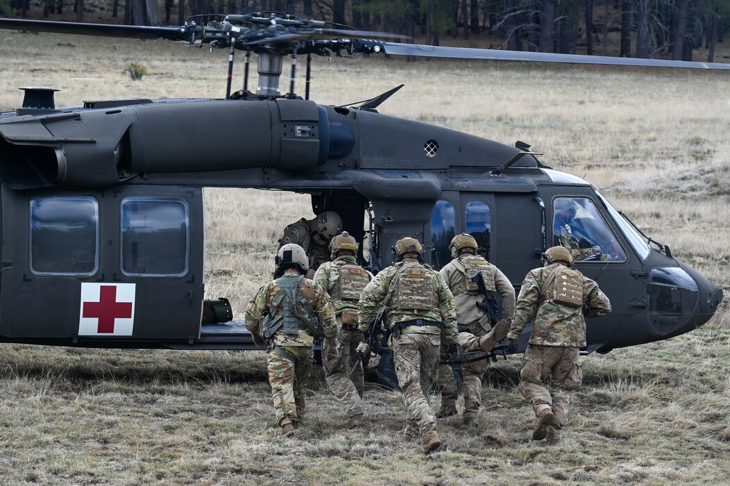 U.S. Air Force Airmen assigned to the 56th Civil Engineer Squadron Explosive Ordnance  Disposal flight evacuate a simulated casualty to an Arizona National Guard UH-60 Black Hawk, assigned to the ANG Silverbell Army Heliport in Marana, Arizona, during exercise Operation Pegasus at Camp Navajo, Arizona, April 21-26, 2024.