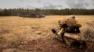 U.S. Air Force 56th Civil Engineer Squadron Explosive Ordnance Disposal gear lies on the ground in front of an Arizona National Guard UH-60 Black Hawk, assigned to the ANG Silverbell Army Heliport in Marana, Arizona, during Operation Pegasus at Camp Navajo, Arizona, April 21-26, 2024.