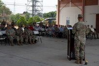 A photo of a service member talking to a group.