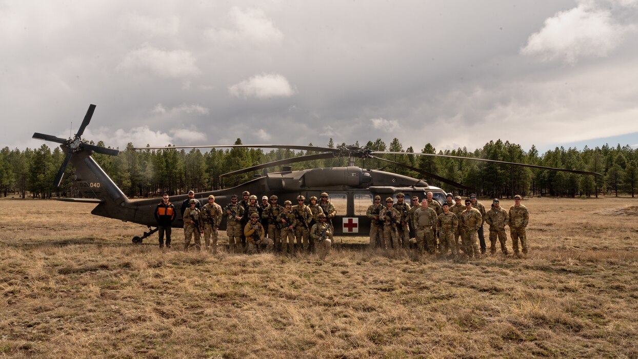 U.S. Air Force Airmen assigned to the 56th Civil Engineer Squadron Explosive Ordnance Disposal flight, and U.S. Army Soldiers assigned to the Arizona National Guard Silverbell Army Heliport in Marana, Arizona, pose for a group photo in front of an ANG medical evacuation UH-60 Black Hawk, during Operation Pegasus at Camp Navajo, Arizona, April 21-26, 2024.