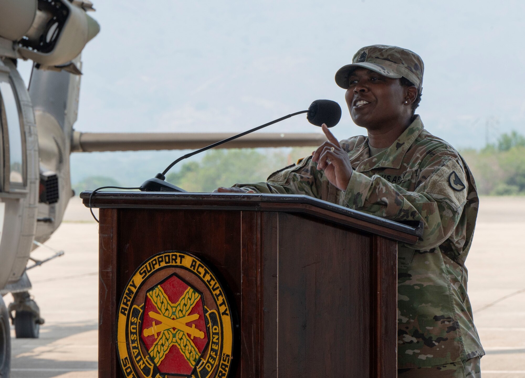 A photo of a service member talking to a group.