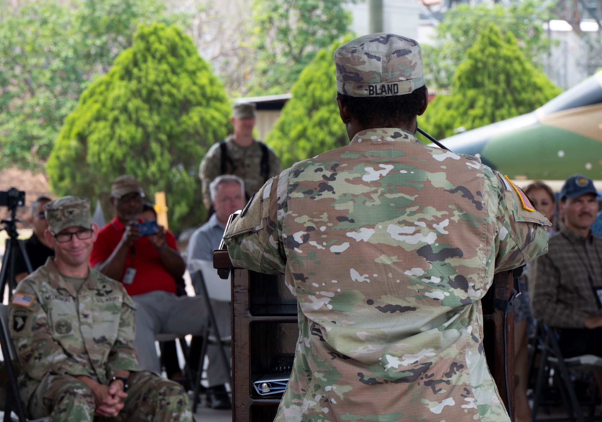 A photo of a service member talking to a group.