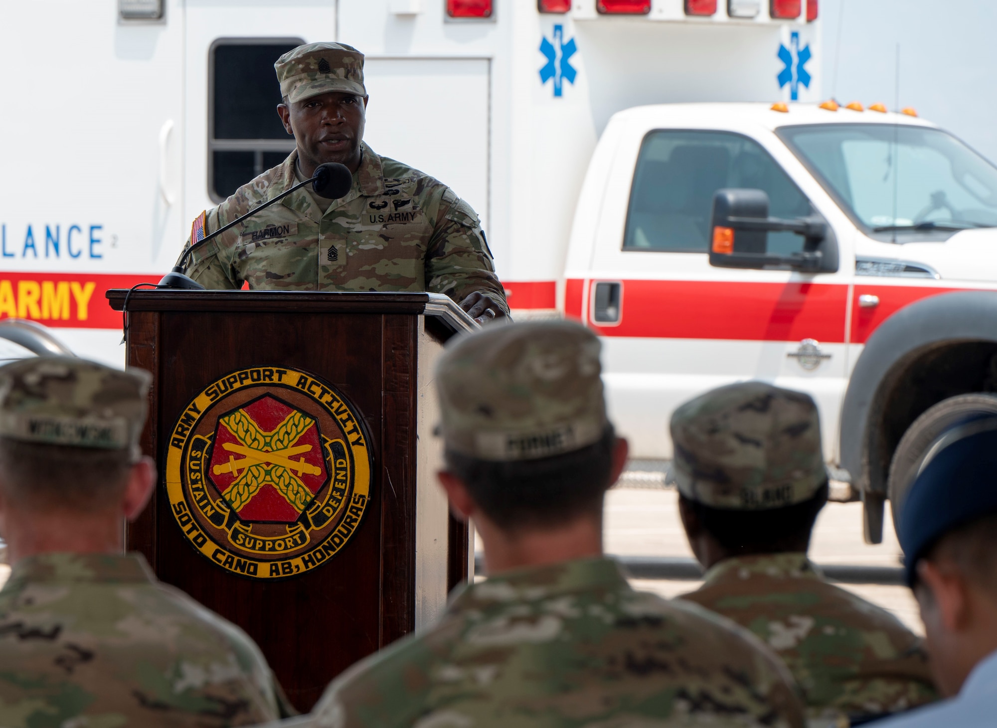 A photo of a service member talking to a group.