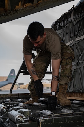 A U.S. Air Force port operations Airman prepares to load pallets of humanitarian aid destined for Gaza aboard a C-130J Super Hercules at an undisclosed location within the U.S. Central Command area of responsibility, April 30, 2024. The U.S. has prioritized the delivery of humanitarian aid to relieve the suffering of civilians affected by the ongoing crisis in Gaza. (U.S. Air Force photo)