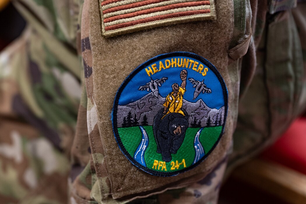 A custom patch sits on the sleeve of a service members uniform.