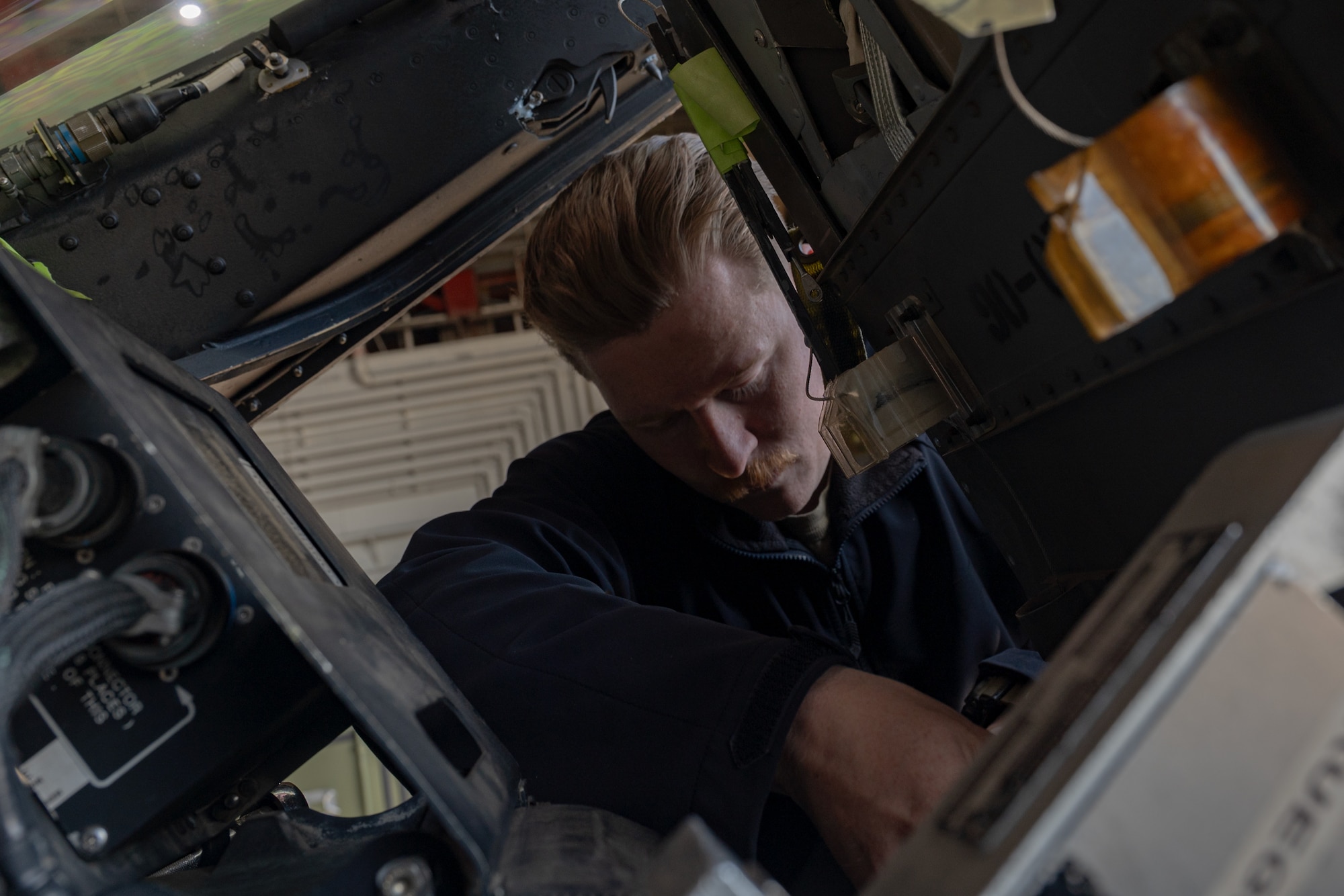 A service member performs maintenance.