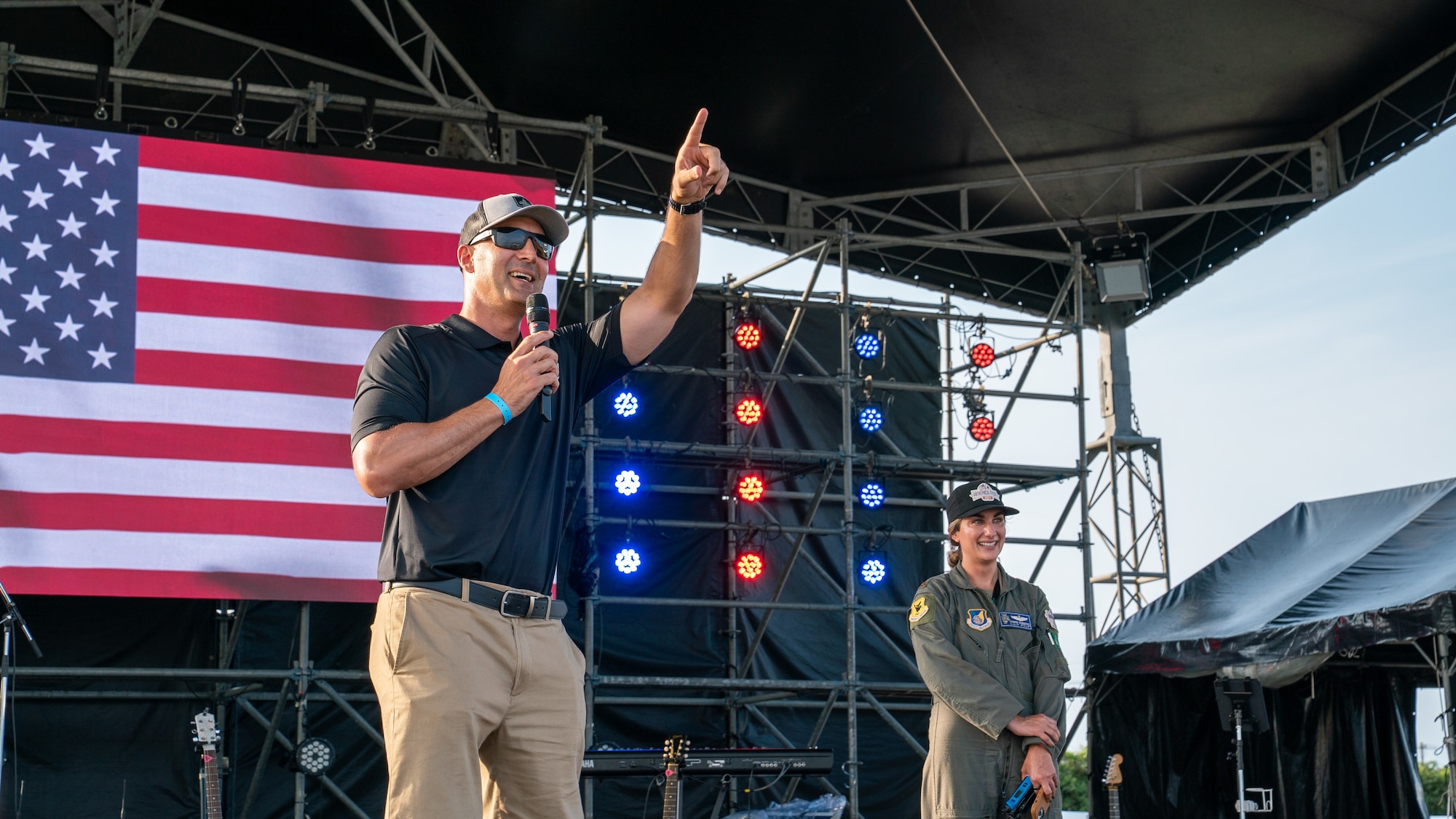 U.S. Air Force Chief Master Sgt. Brandon Wolfgang, 18th Wing command chief, speaks to America Fest 2024 attendees from the main stage.