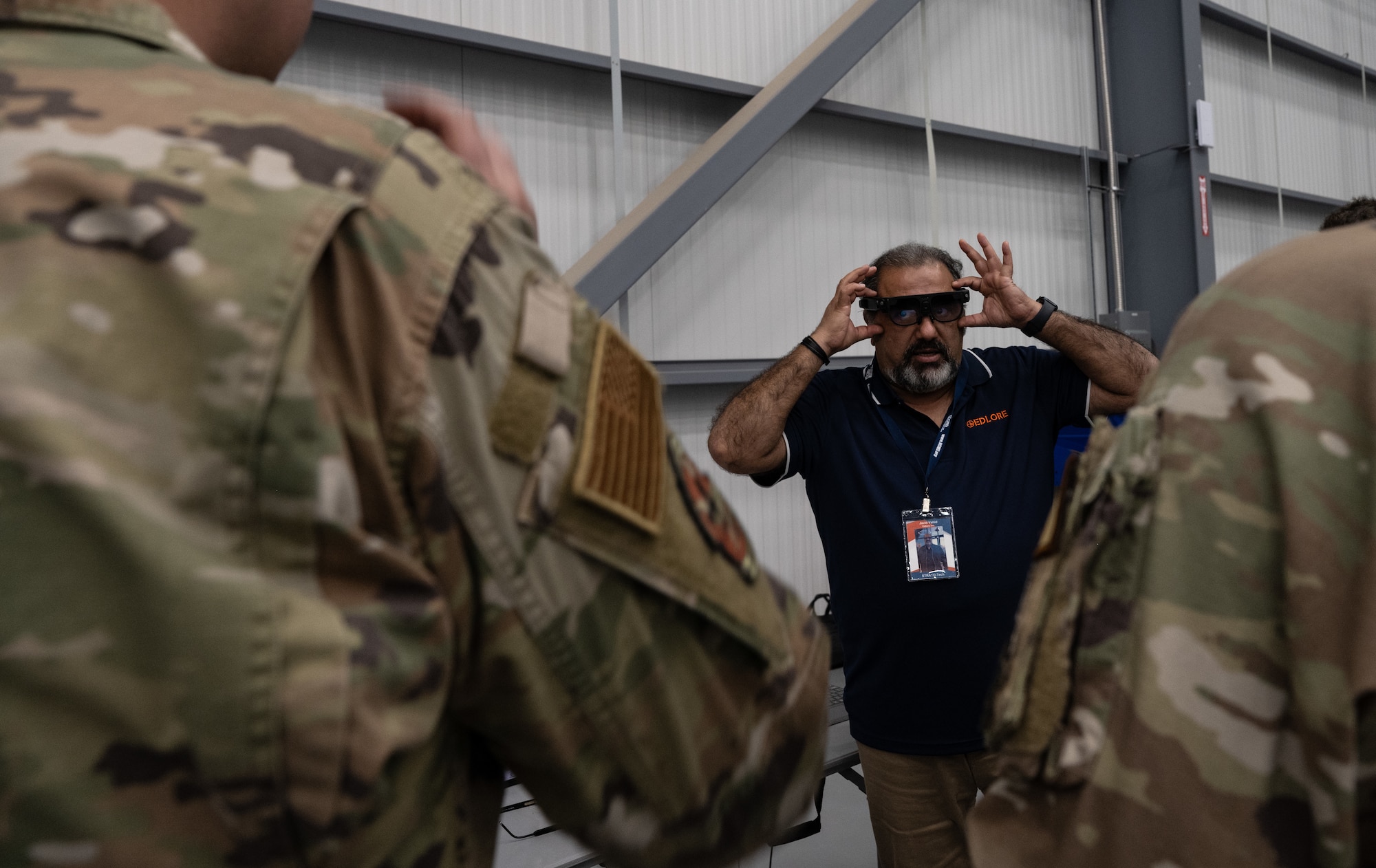 Javid Vahid, Edlore president, demonstrates how to use his company’s voice-activated glasses during STRATO-Tech, a convention for the sustainment of the KC-135 Stratotanker, April 22, 2024, in Wichita, Kansas. Air Mobility Command, the National Center for Manufacturing Sciences, Wichita State University’s National Institute for Aviation Research, and U.S. Transportation Command partnered to create an innovative testbed that keeps the KC-135 relevant and fit to fight. (U.S. Air Force photo by Staff Sgt. Tryphena Mayhugh)