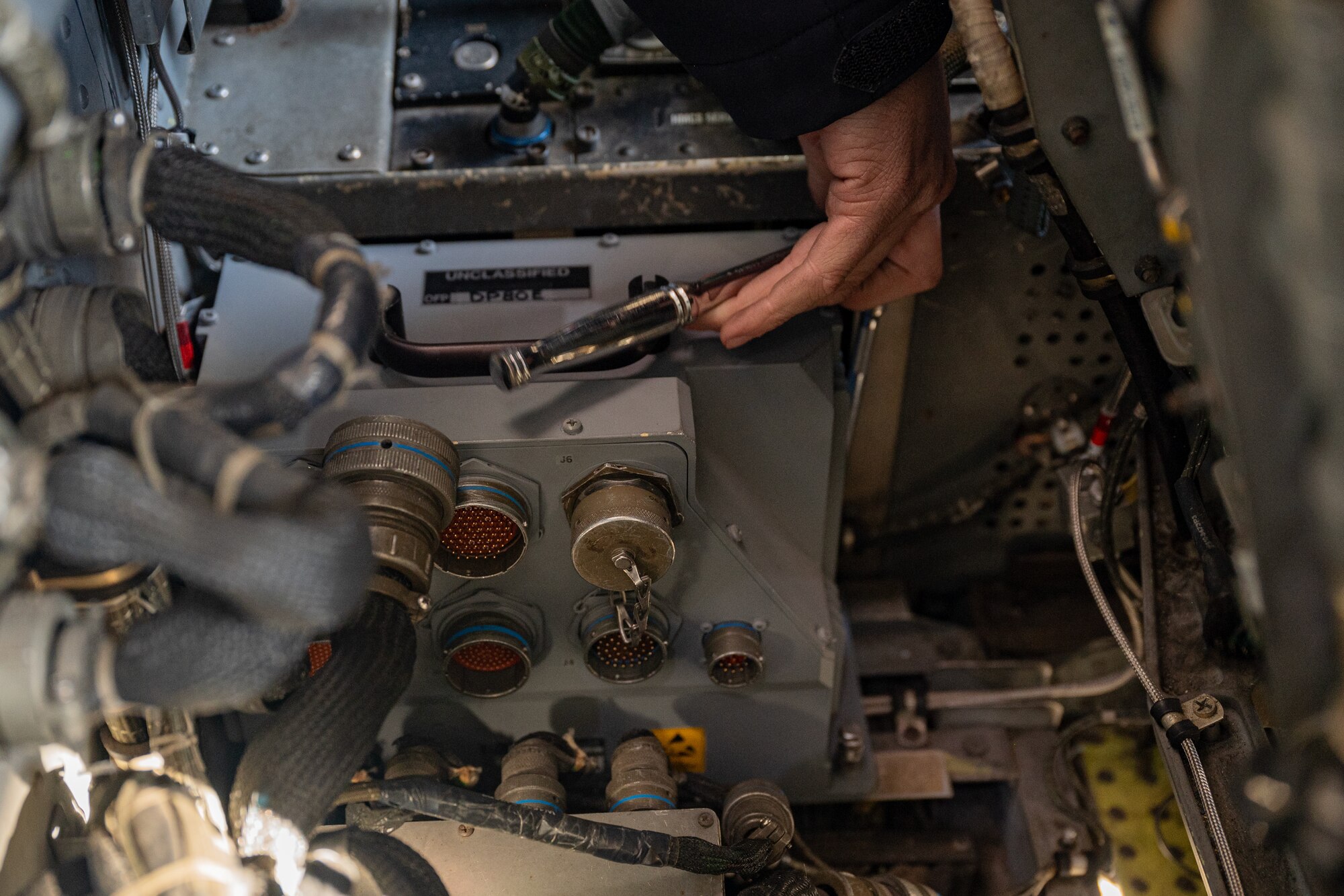 A service member performs maintenance.
