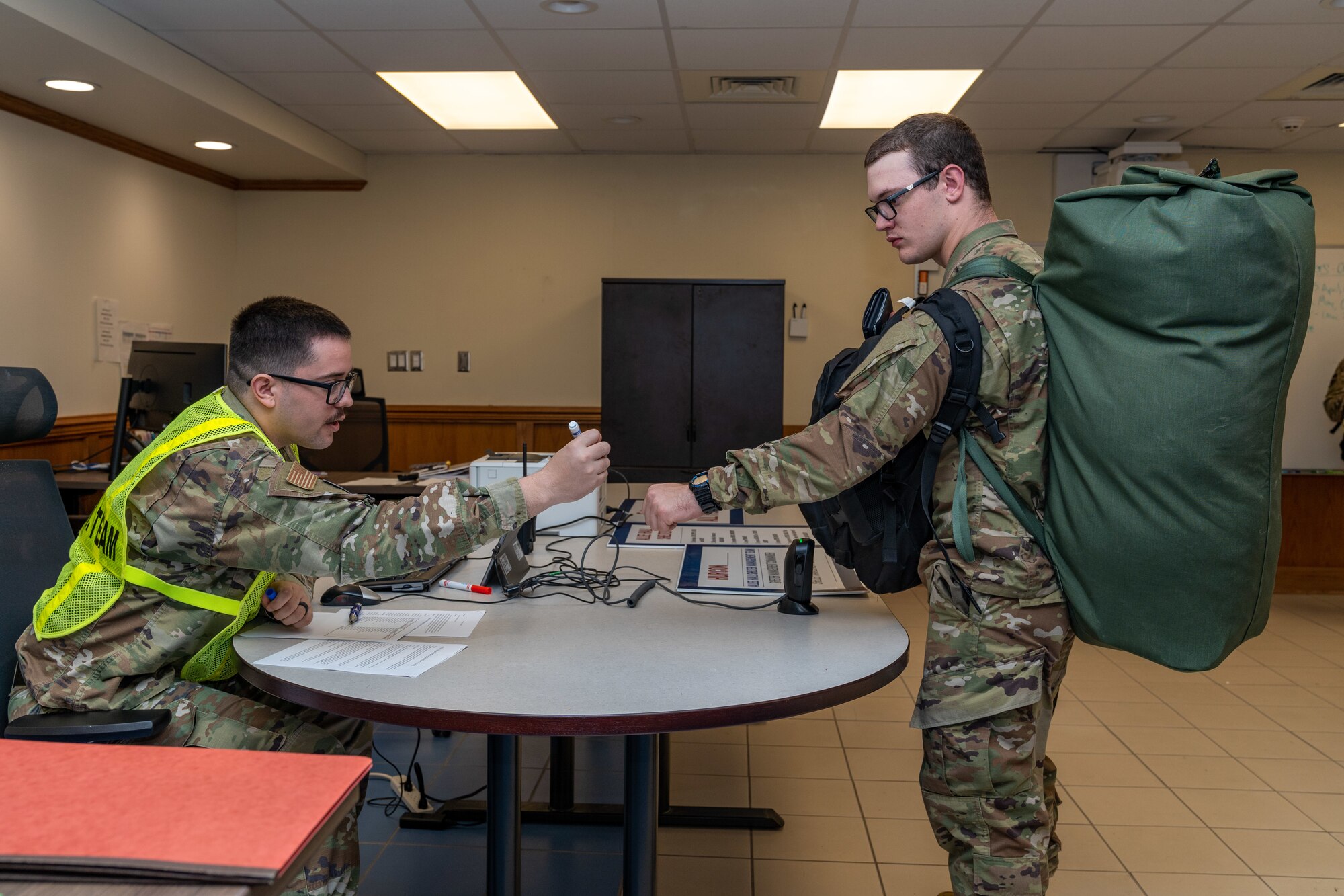 U.S. Air Force Staff Sgt. Joel Walls, 335th Training Squadron personnel chief, checks in students to an in-processing center to a shelter during a hurricane exercise at Keesler Air Force Base, Mississippi, April 26, 2024. Keesler personnel participated in exercise scenarios in preparation for hurricane season. (U.S. Air Force photo by Andrew Young)