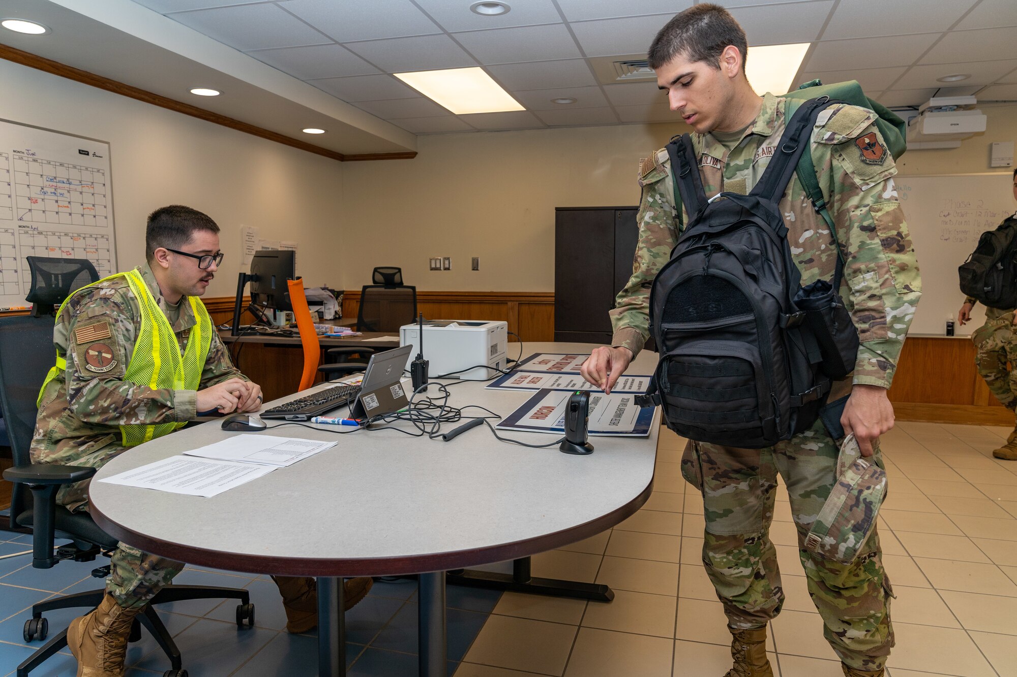 U.S. Air Force Staff Sgt. Joel Walls, 335th Training Squadron personnel chief, checks in students to an in-processing center to a shelter during a hurricane exercise at Keesler Air Force Base, Mississippi, April 26, 2024. Keesler personnel participated in exercise scenarios in preparation for hurricane season. (U.S. Air Force photo by Andrew Young)