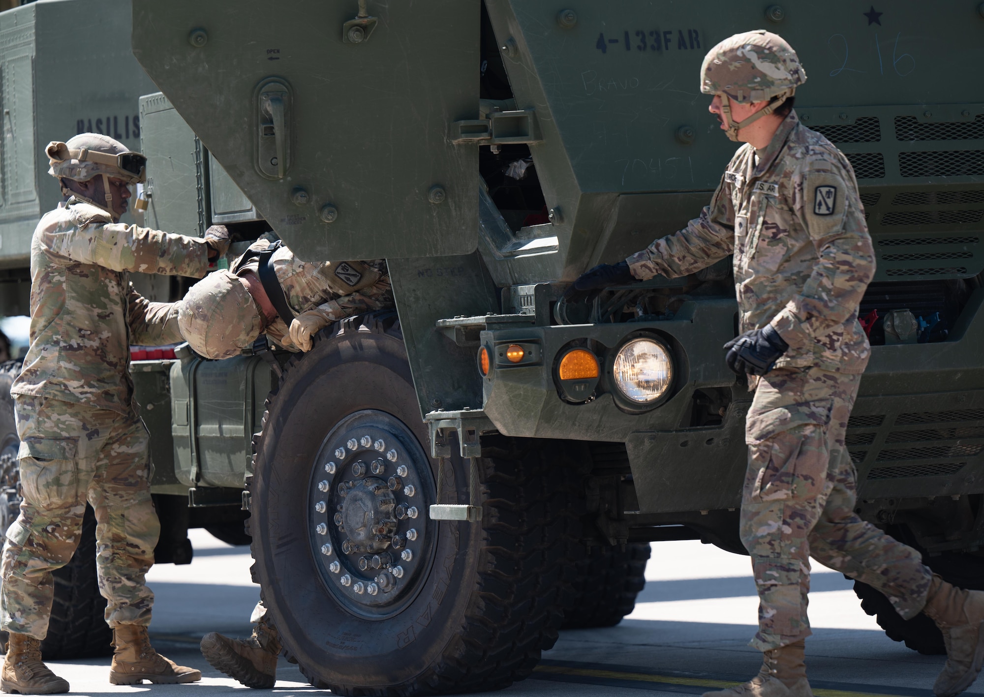 U.S. Army National Guard 4th Battalion, 133rd Field Artillery Regiment members deflate the tires of a M142 High Mobility Artillery Rocket System (HIMARS)  before loading onto a U.S. Air Force C-130J Super Hercules, at Ramstein Air Base, Germany, July 29, 2024.