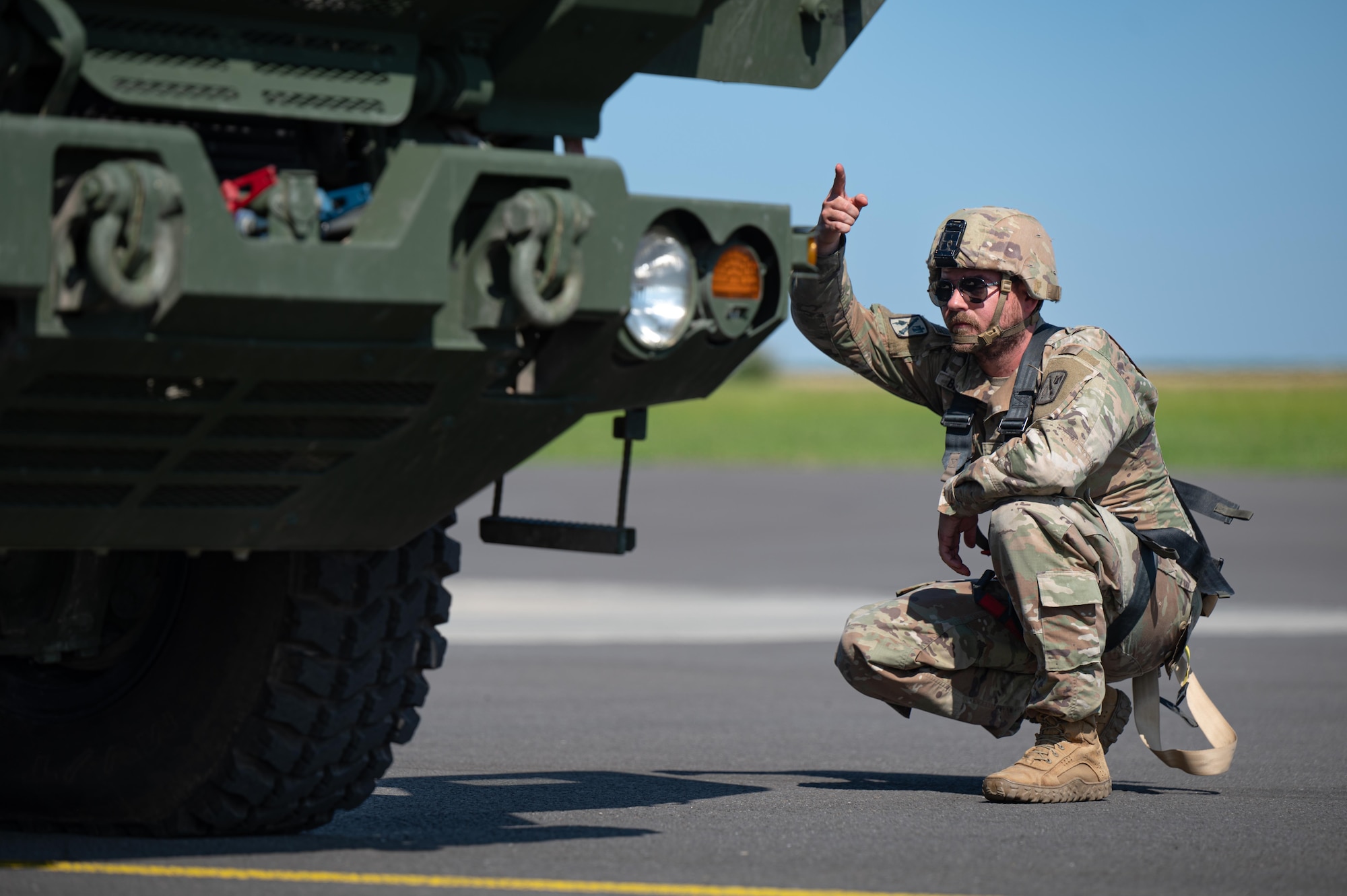 U.S. Army Sgt. Cody Bridges, 4th Battalion,133rd Field Artillery Regiment M142 High Mobility Artillery Rocket System (HIMARS) crewmember, deflates tires before loading onto a U.S. Air Force C-130J Super Hercules, at Chievres Air Base, Belgium, July 29, 2024.