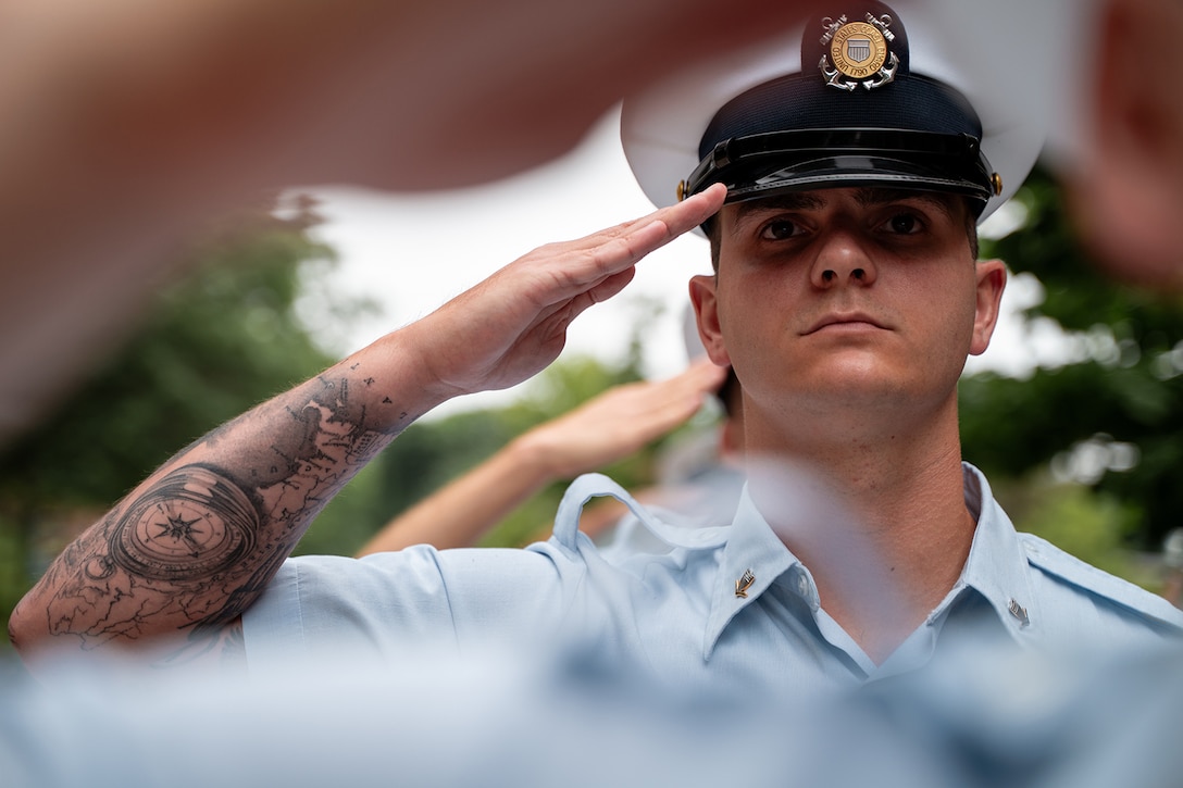 Close-up of a Coast Guard student saluting.