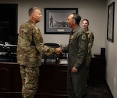 U.S. Air Force Col. Darren Duncan, U.S. Strategic Command command chaplain (left), is greeted by U.S. Air Force Col. Jesse Lamarand, 5th Bomb Wing commander, at Minot Air Force Base, North Dakota, July 30, 2024. The two leaders discussed ongoing initiatives to support the spiritual resilience of Airmen stationed at Minot AFB, highlighting the importance of comprehensive wellness programs for mission readiness and overall well-being. (U.S. Air Force photo by Airman 1st Class Luis Gomez)