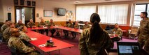 U.S. Air Force Col. Darren Duncan, U.S. Strategic Command command chaplain (center left), attends a mission brief at Minot Air Force Base, North Dakota, July 30, 2024. Chaplains from the 5th Bomb Wing and 91st Missile Wing convened with Duncan to assess the current status and advancements of the Chaplain Corps mission. (U.S. Air Force photo by Airman 1st Class Luis Gomez)