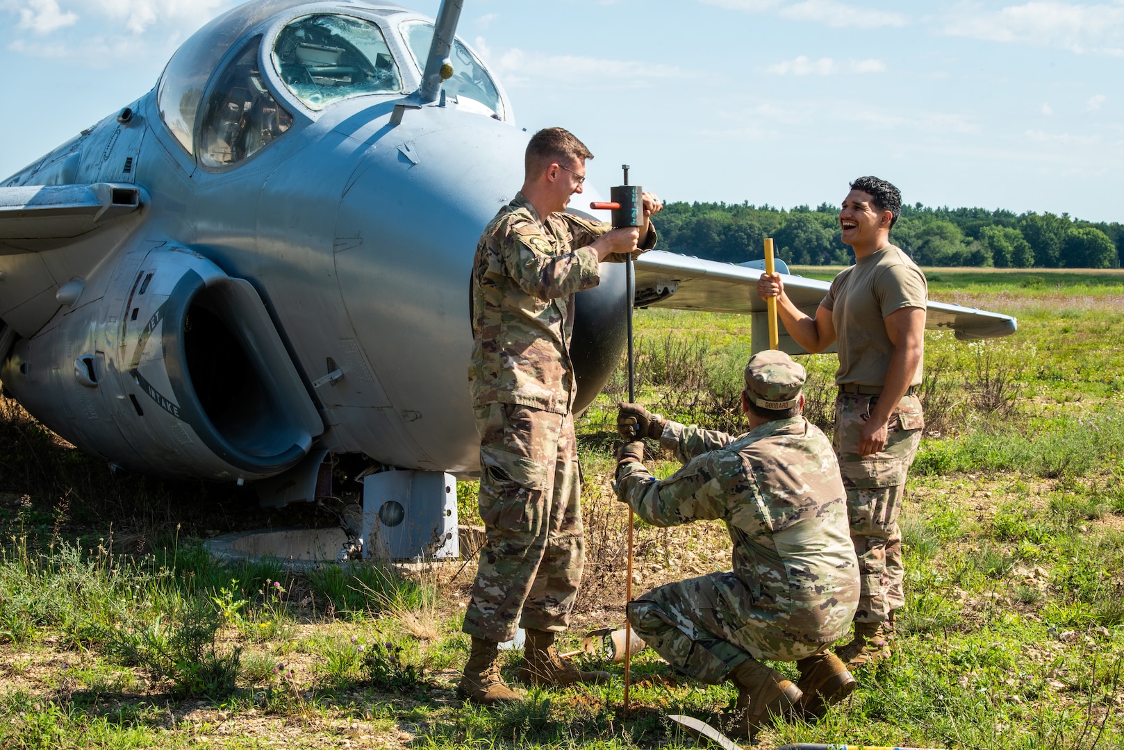 U.S. Air Force Staff Sgt. Nicholas P. Farmer, left, Master Sgt. Richard A. Goddard, middle, both assigned to the 128th Air Refueling Wing, Milwaukee, WI, and Airman 1st Class Ernesto Ibarra, right, assigned to Volk Field Air National Guard base, Camp Douglas, WI, installs a ground rod as part of a practice exercise at Volk Field Air National Guard base, Camp Douglas, Wisconsin, July 16, 2024.