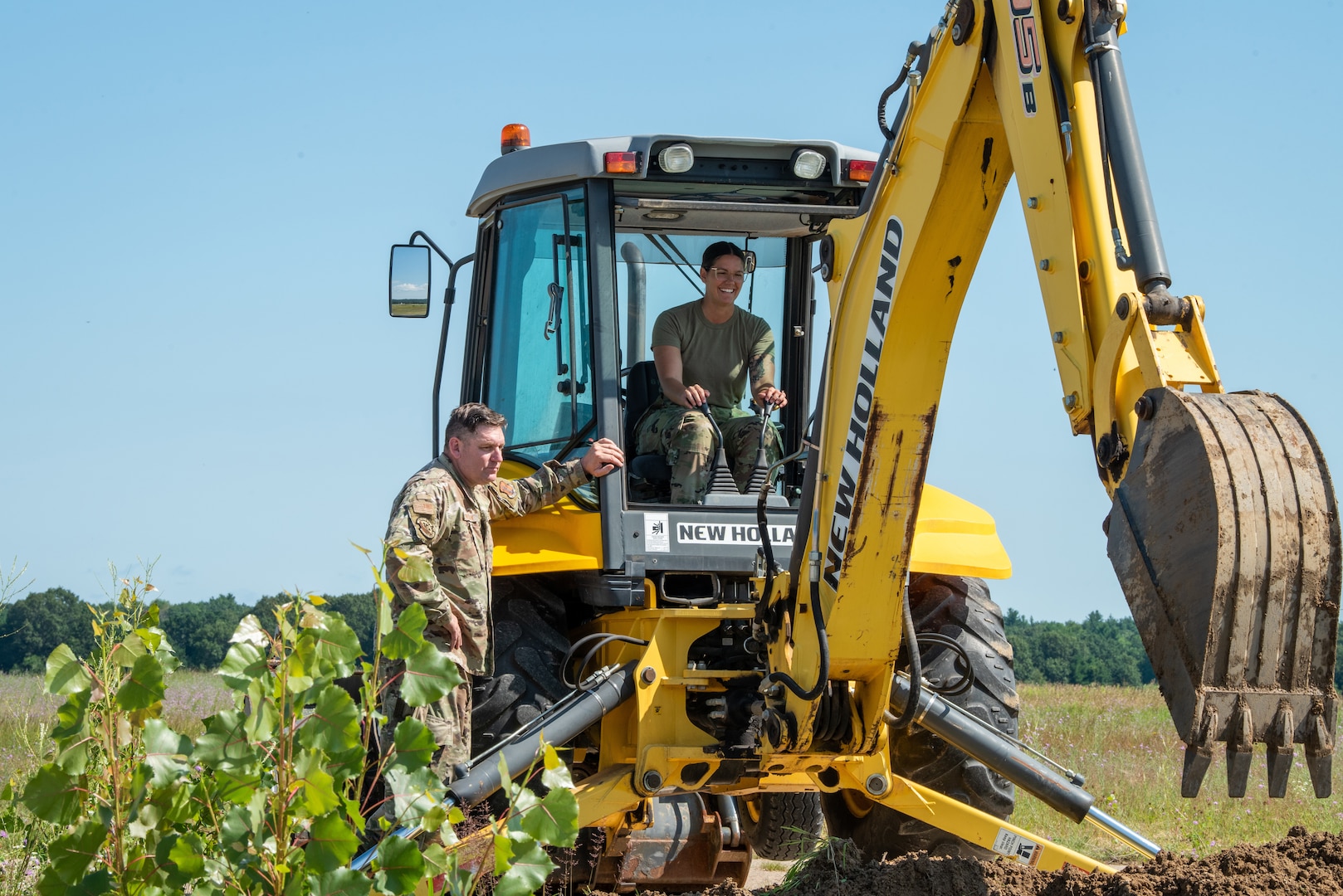 U.S. Air Force Master Sgt. Michael D. Witkowiak, left, and 2nd Lt. Autumn R. Kangas, right, both assigned to the 128th Air Refueling Wing, Milwaukee, WI, practices excavator training at Volk Field Air National Guard base, Camp Douglas, Wisconsin, July 16, 2024.