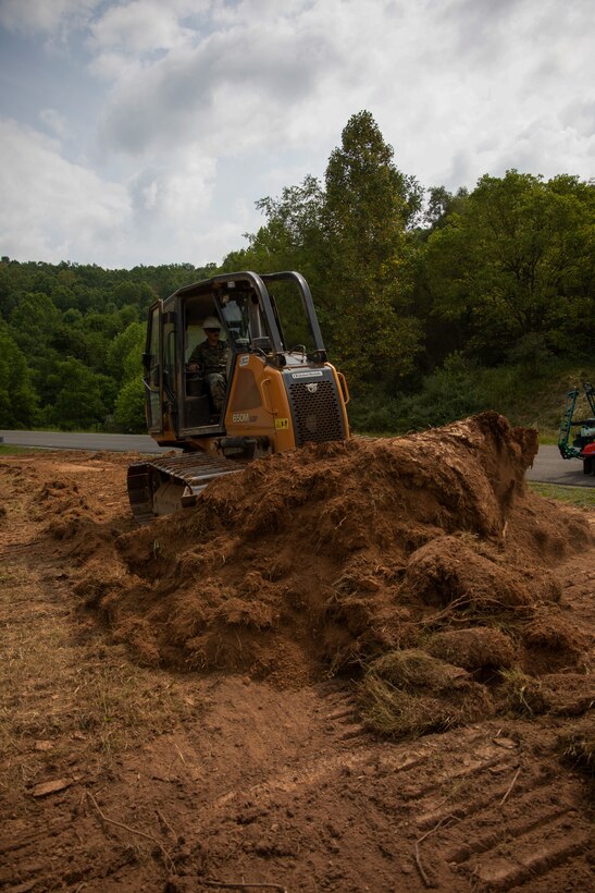 U.S. Marine Corps Sgt. Wiley D. Price, engineer equipment operator, Landing Support Company, Combat Logistics Regiment 45, 4th Marine Logistics Group, Marine Forces Reserve, operates excavation equipment during Innovative Readiness Training, Stonewall State Park, West Virginia, July 25, 2024.  The mission of IRT is to produce mission-ready forces through military training opportunities that provide services for American communities. (U.S. Marine Corps photo by Lance Cpl. Kanoa Thomas)